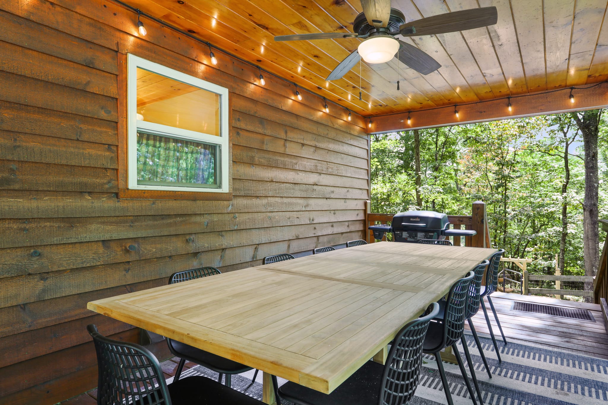 This dining space is on the front patio and has a view of the yard and fire pit!
