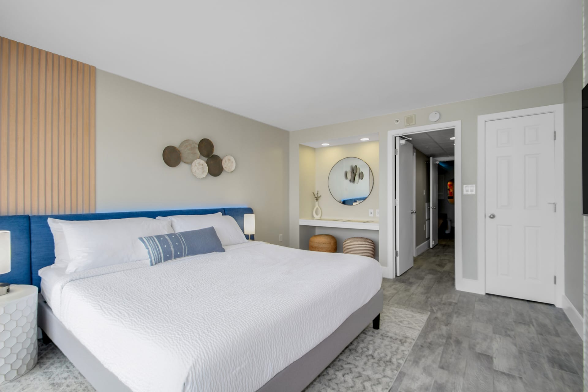 Retreat to this elegant bedroom featuring a luxurious king bed, chic decor, and a cozy vanity nook. Thoughtfully designed with modern accents and soft lighting, this space offers a perfect blend of style and comfort for a restful night’s sleep.