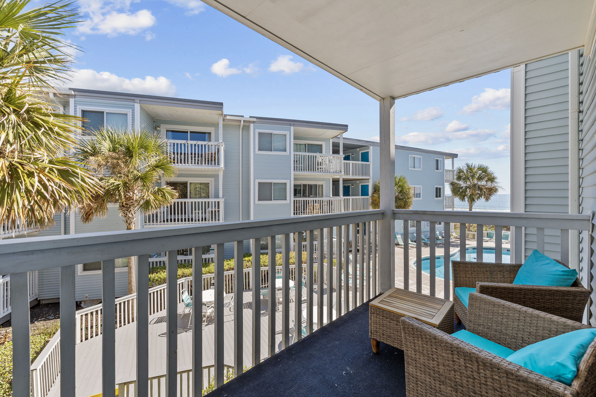 Enjoy this relaxing private balcony overlooking the pool and ocean!