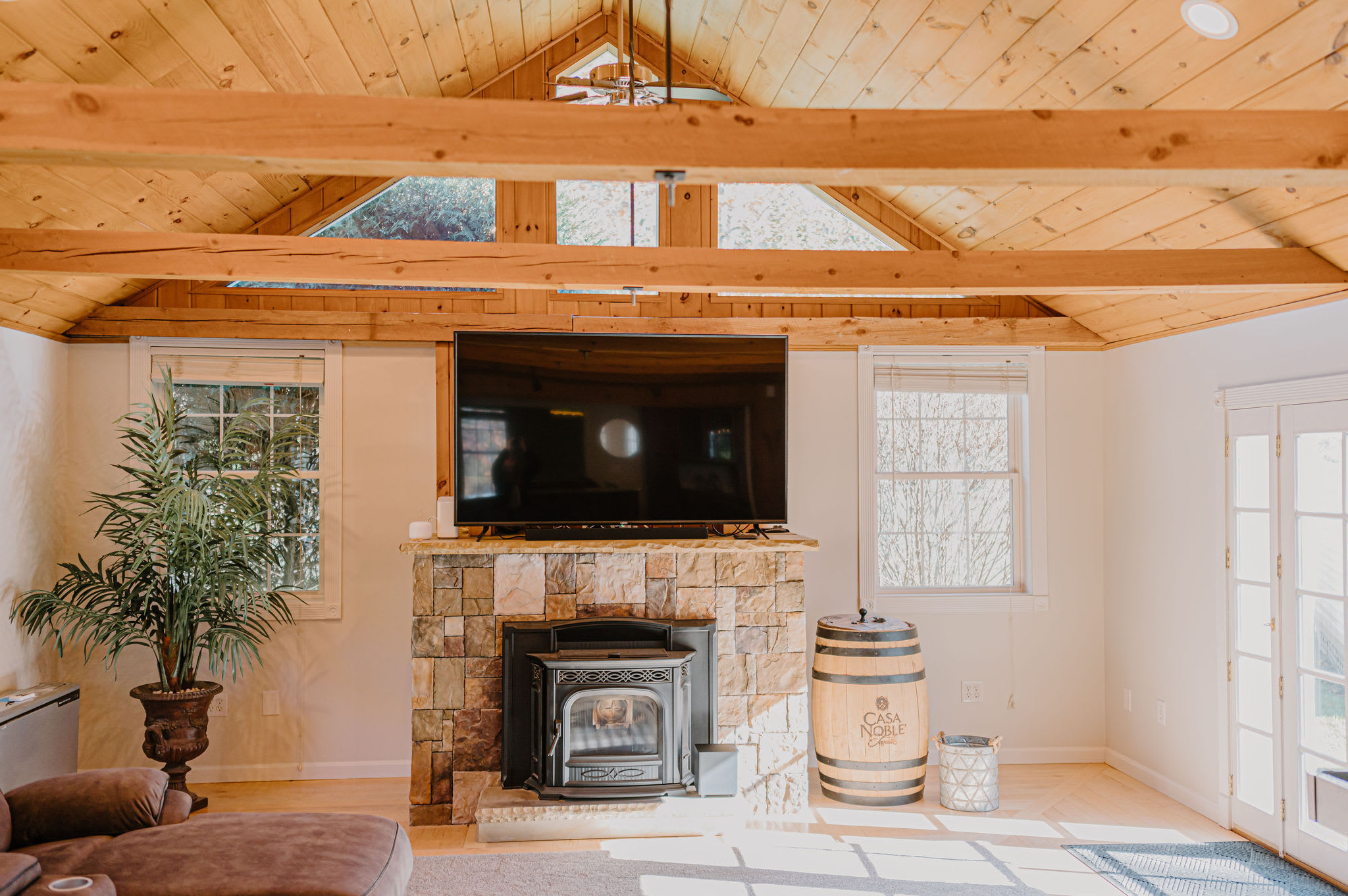 The spacious living room has 15' cathedral ceilings with beautiful wood beams