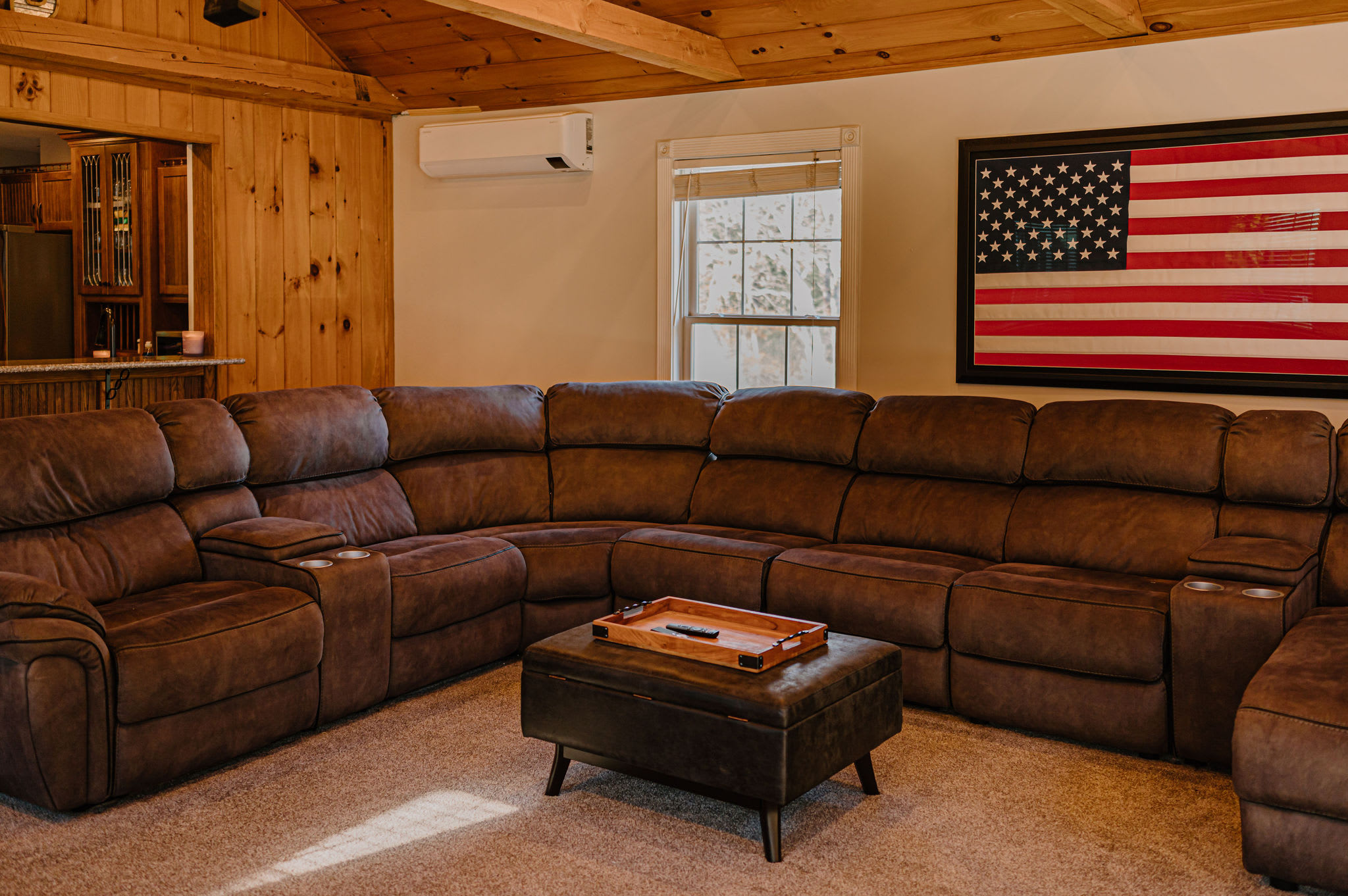 Spacious living room features a super comfy sectional and a 75" Smart TV for the game and movie nights.