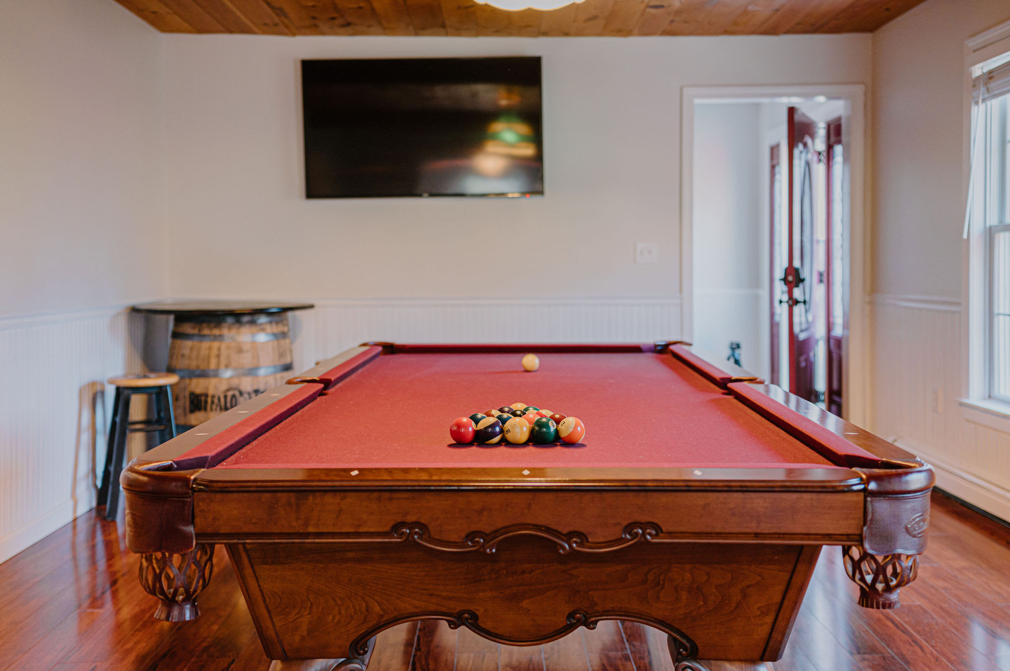 Enjoy the regulation 8 foot pool table with Smart TV, seating at the Buffalo Trace barrel table