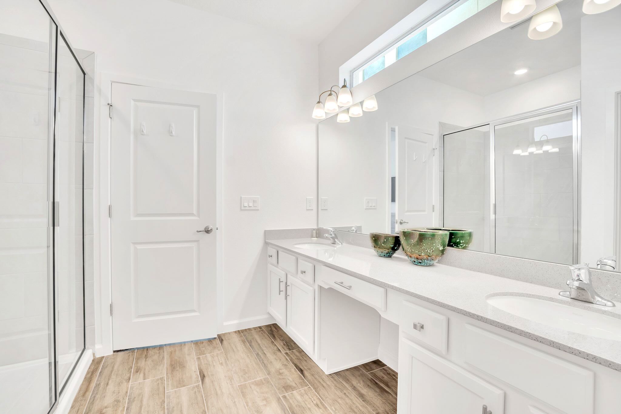 Spacious Ensuite Bathroom Featuring Dual Vanity, Walk-In Glass Shower, And Modern Fixtures