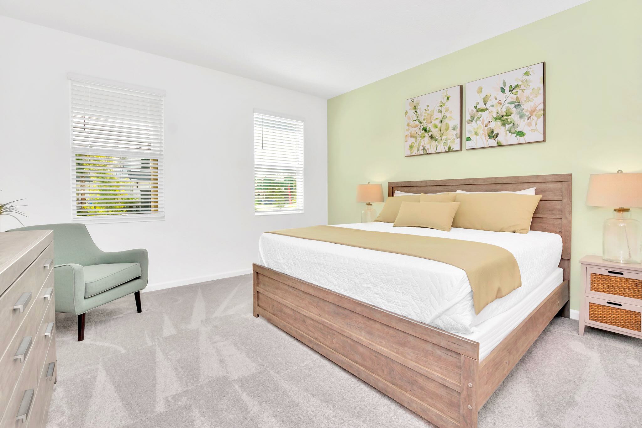 Modern King Bedroom Featuring Soft Green Accents, Sleek Design, And Ample Natural Light
