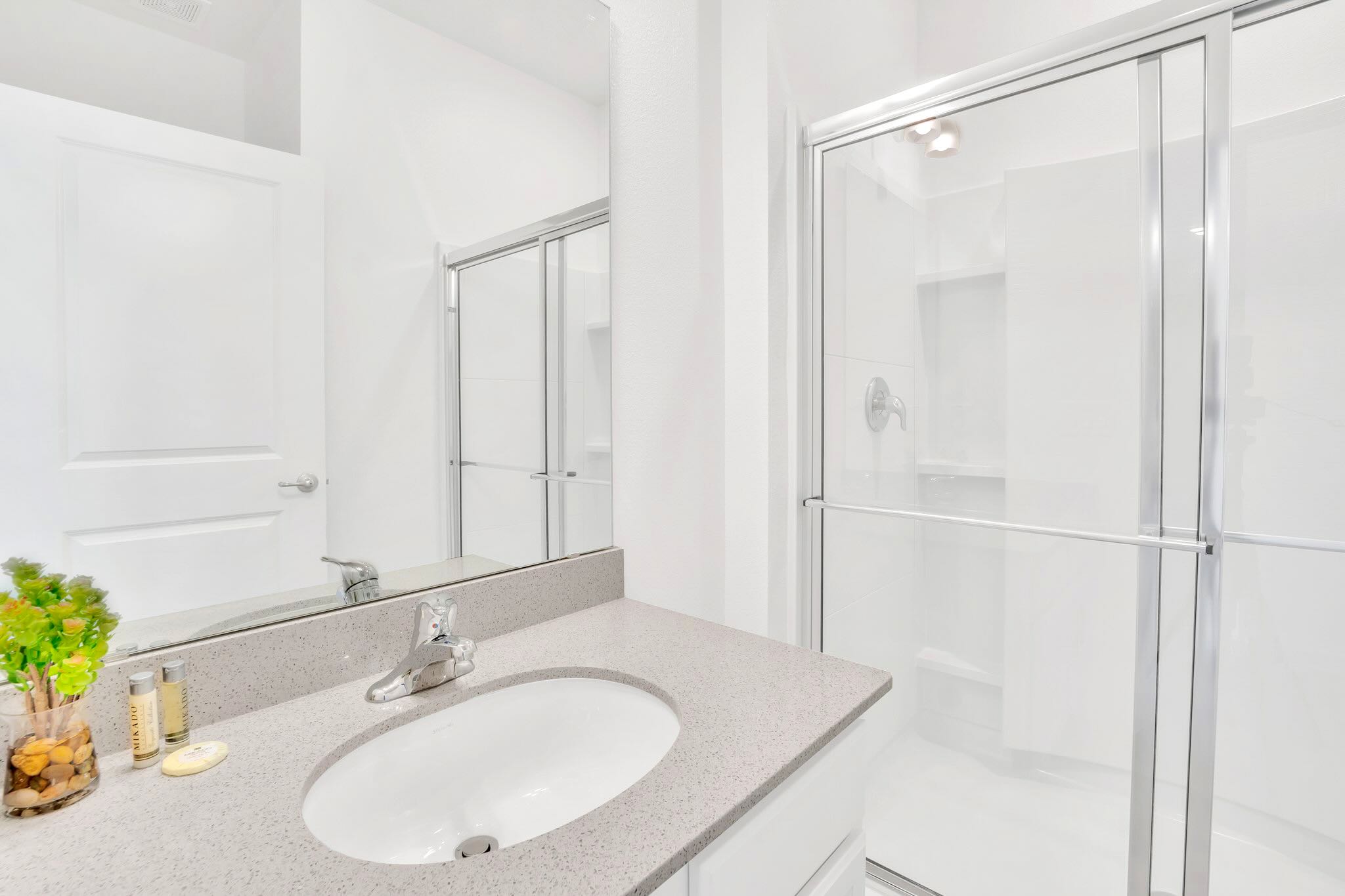 Modern Bathroom Featuring Polished Vanity, Walk-In Glass Shower, And Sleek Fixtures