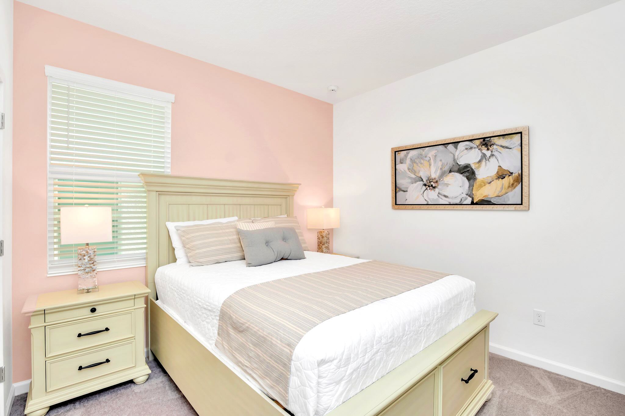 Beautiful Queen Bedroom Featuring Soft Pink Accents, Elegant Decor, And Ample Space