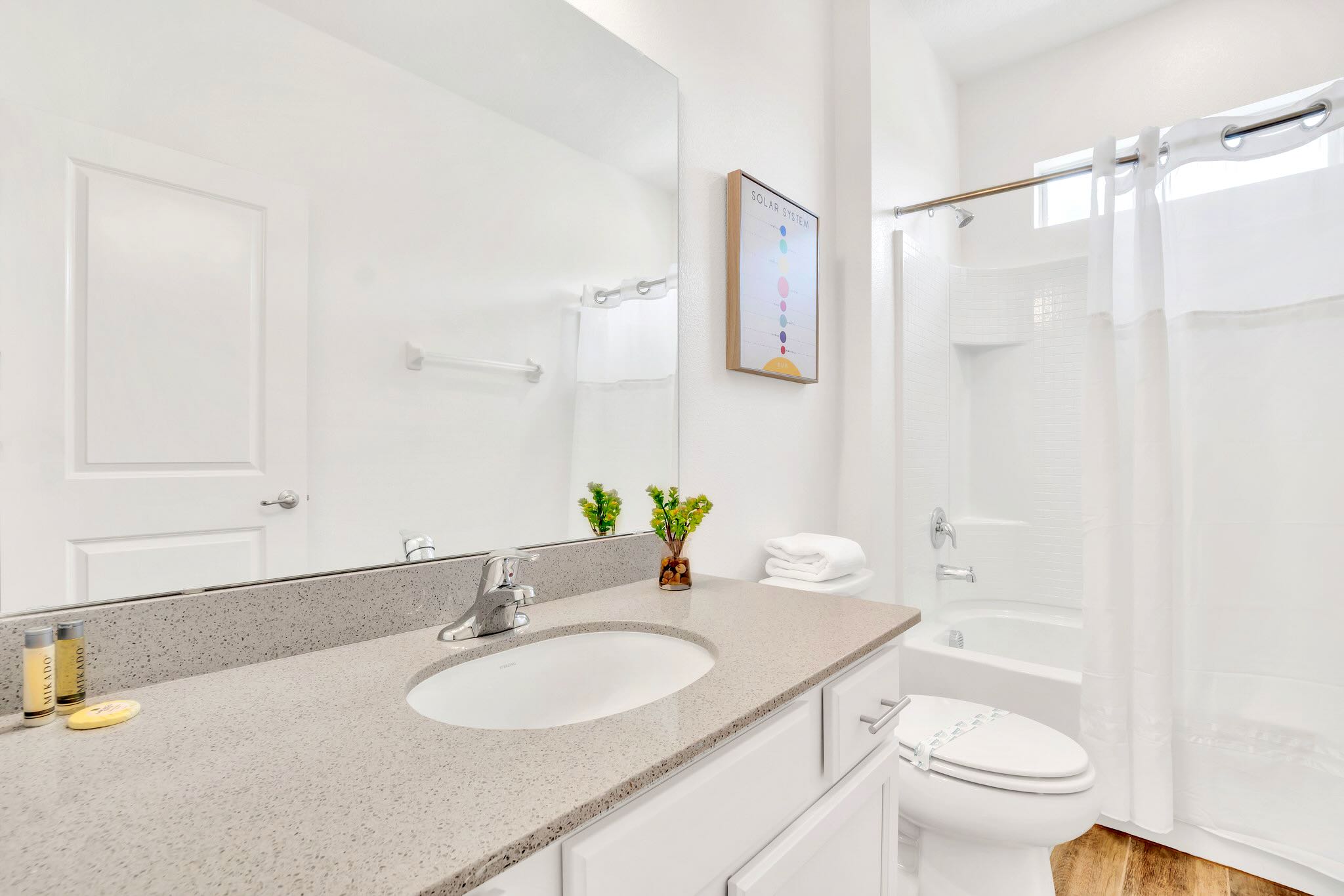 Bright Bathroom Featuring Double Vanity, Full Bathtub, And Sleek Modern Design