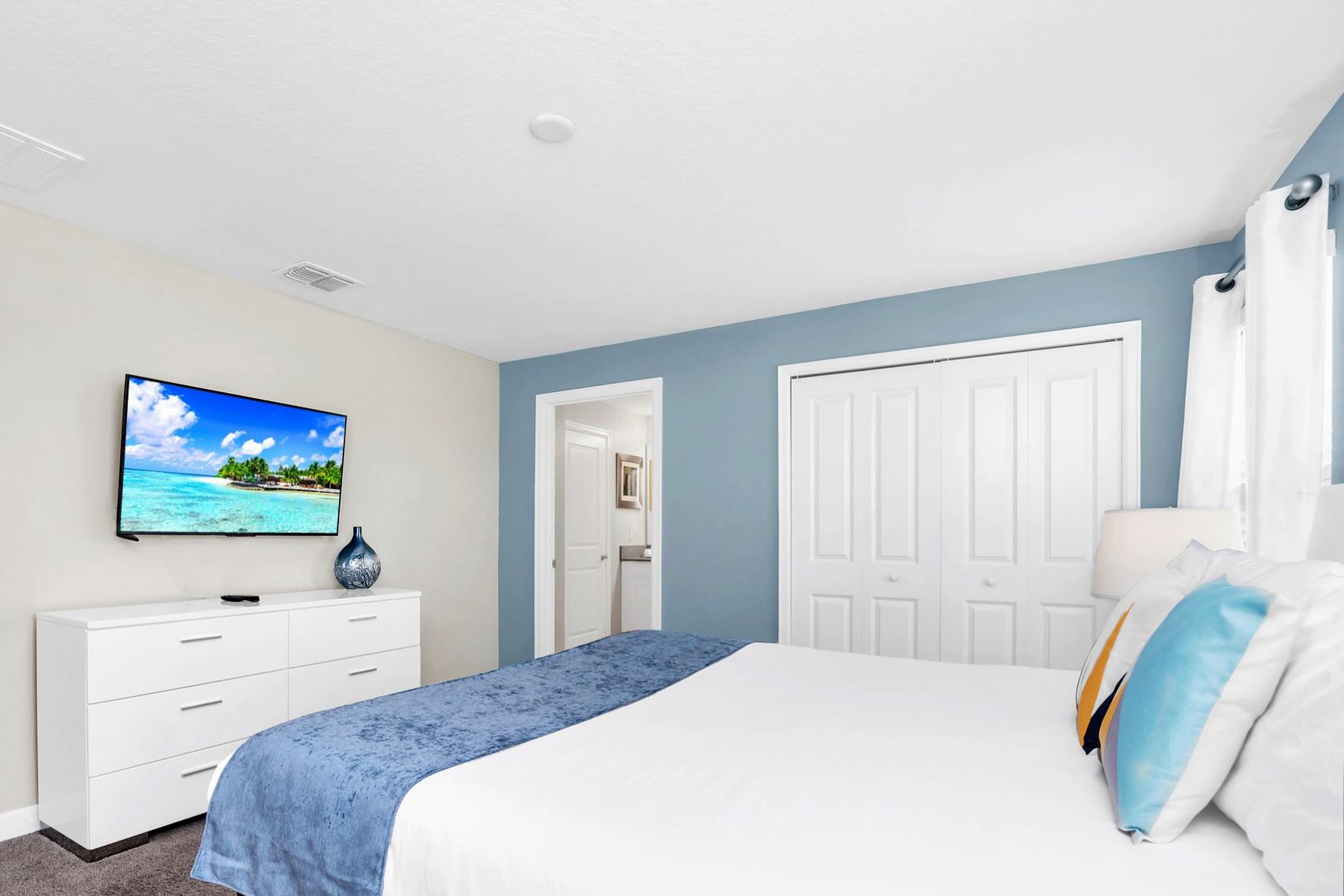 Master Bedroom With A King Bed And A Smart TV For Relaxation
