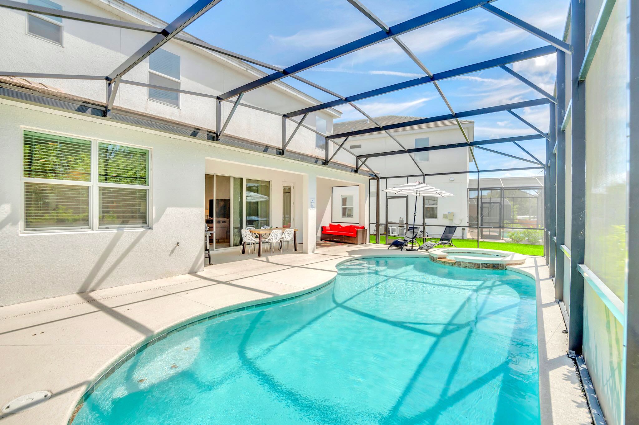 Spacious Pool Area With Easy Access To The House And Outdoor Seating