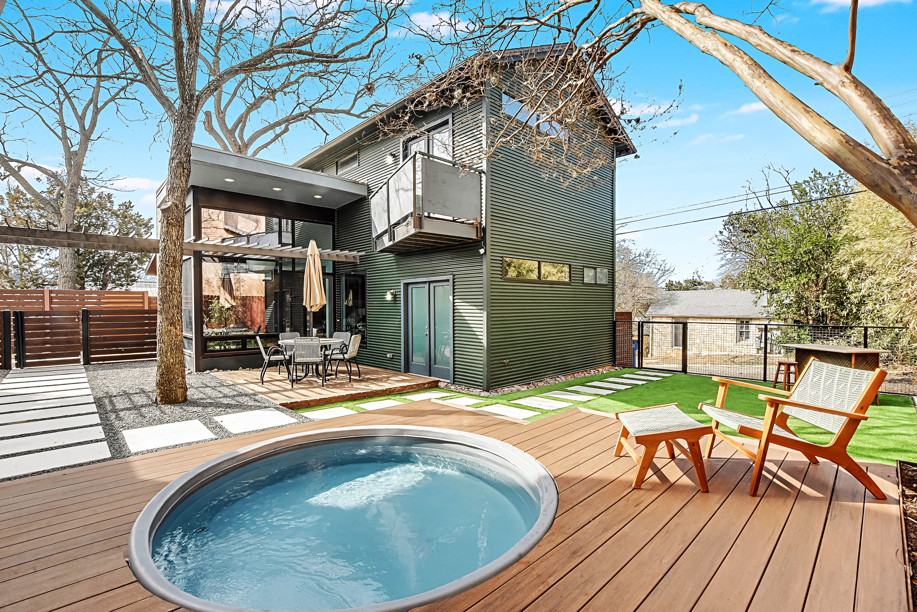 Heated Cowboy pool, deck, and artificial turf along with outdoor dining and tiki bar for 2