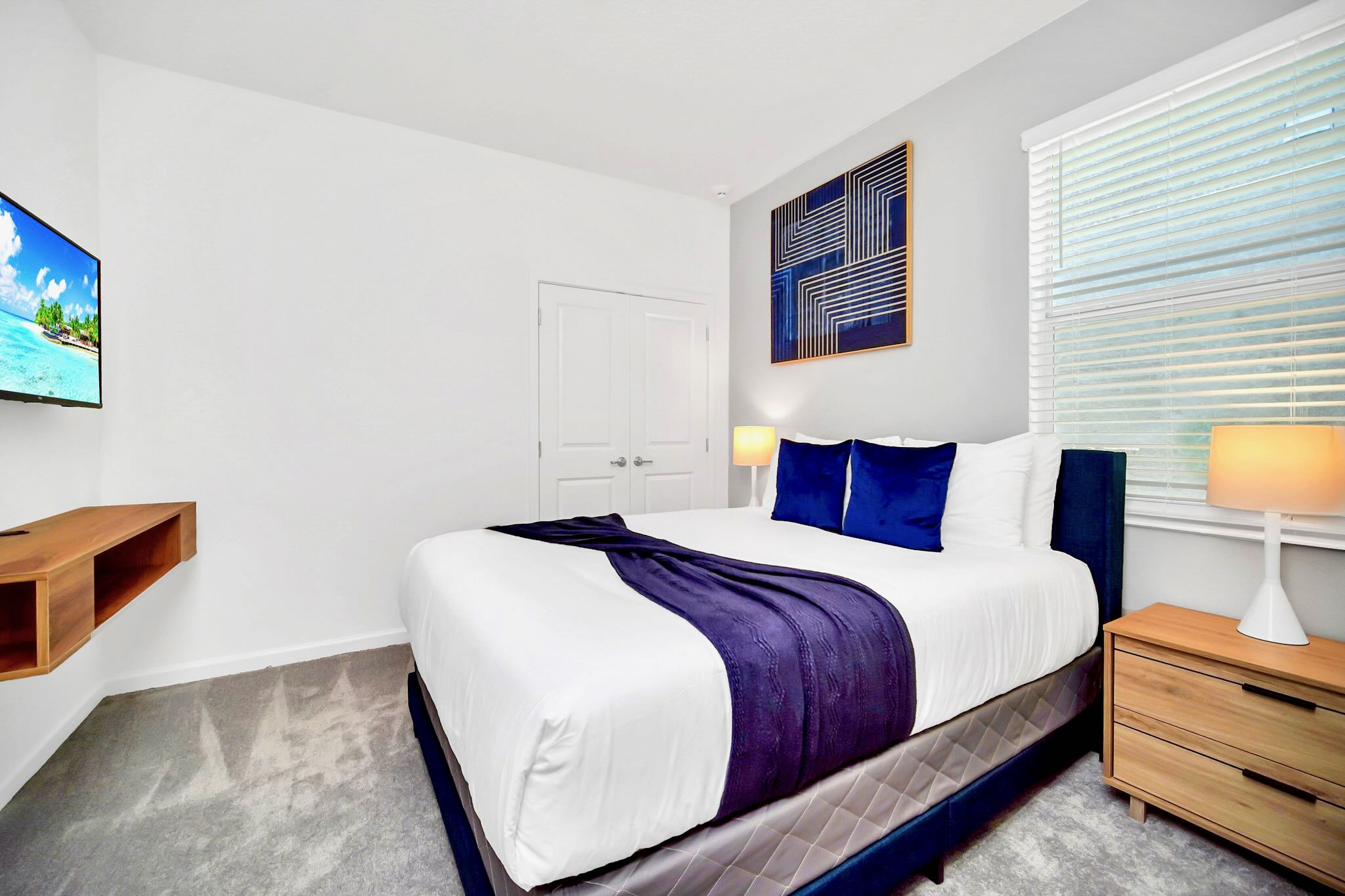 Modern King Bedroom With A Smart TV And Sleek Wooden Accents