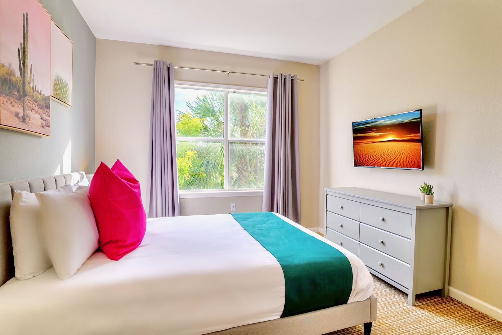 Bright Queen Bedroom Featuring A Smart TV And Vibrant Decor