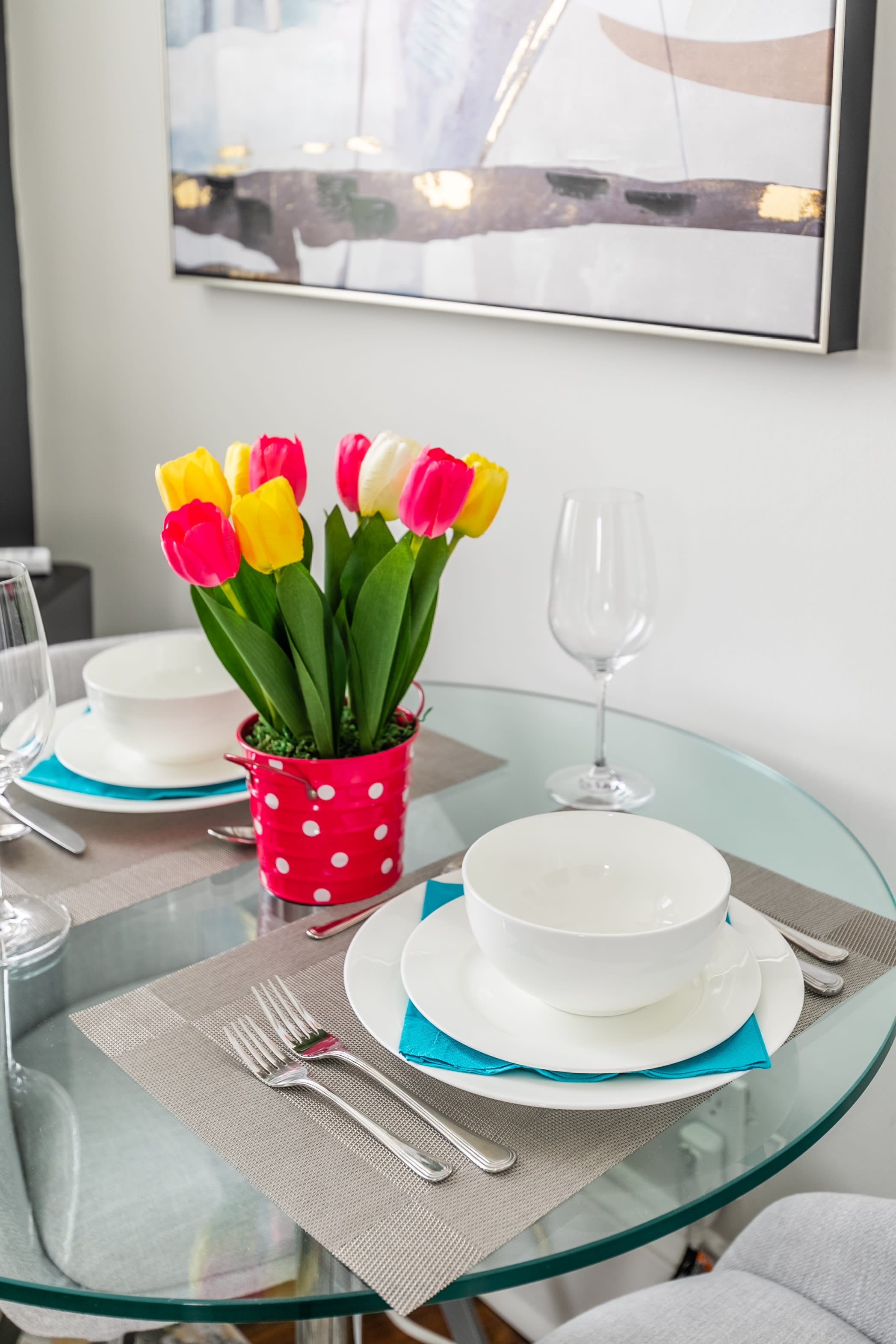 Dining Area With Elegant Glass Table, Two Chairs, And Beautiful Floral Decoration