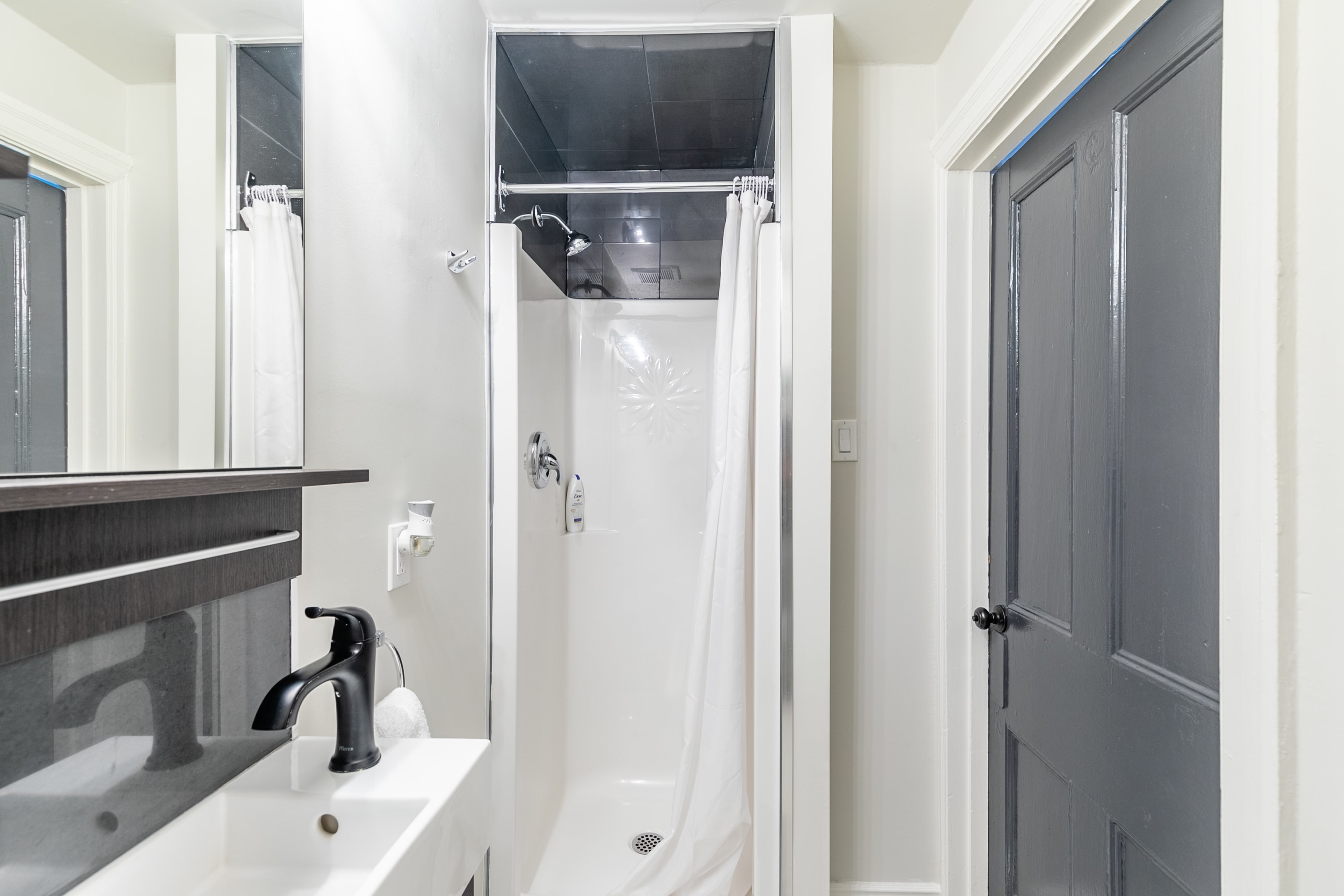 Compact And Modern Bathroom With Clean Design, Featuring A Spacious Shower
