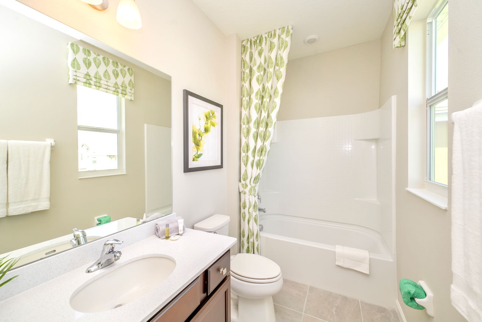 Modern Bathroom With Sleek Vanity And Green-Toned Decor