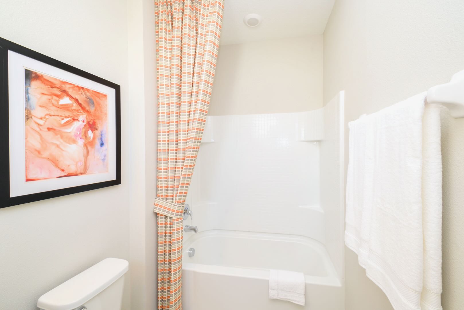Bathroom With Bathtub And Colorful Coral-Themed Accents