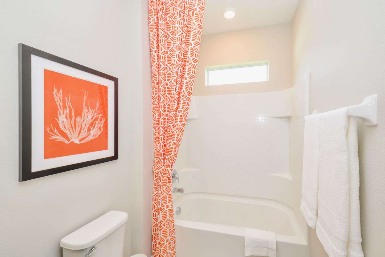 Bathroom With A Relaxing Bathtub And Bright Curtain Details