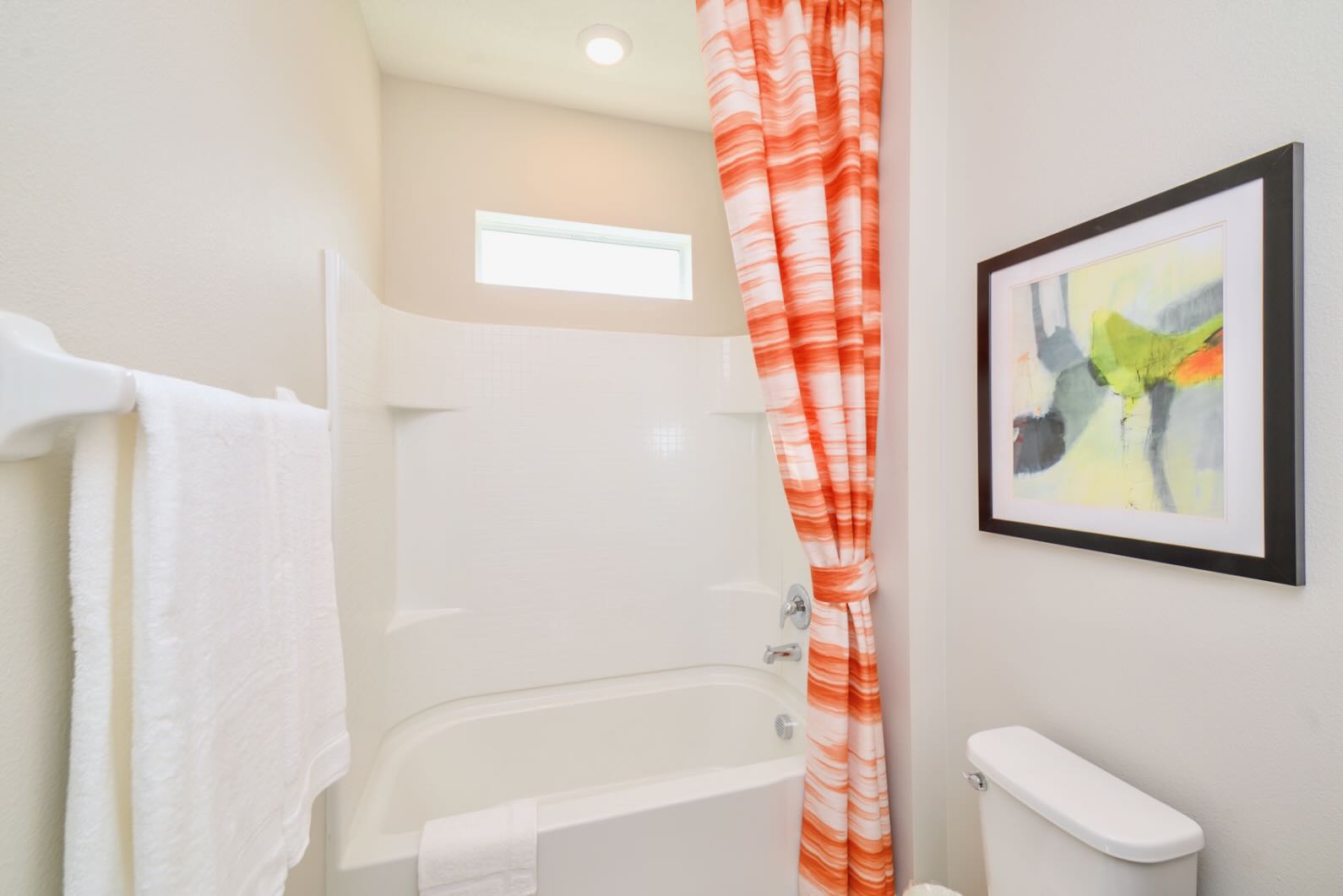 Bathroom Featuring Bathtub And Eye-Catching Orange Curtain
