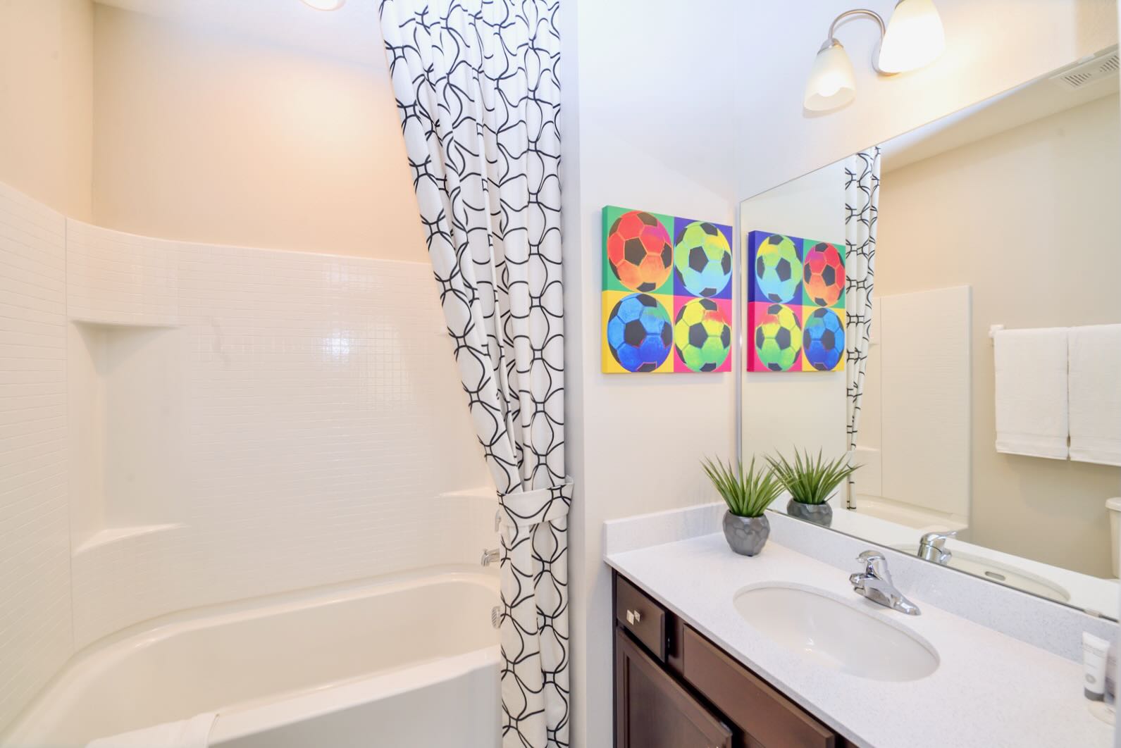 Bathroom With A Relaxing Bathtub And Bright Curtain Details