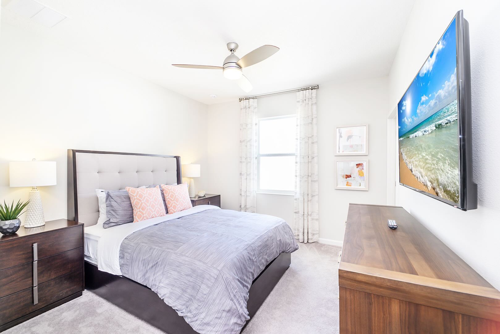 Bright Bedroom With Comfortable Bedding And Large Smart TV