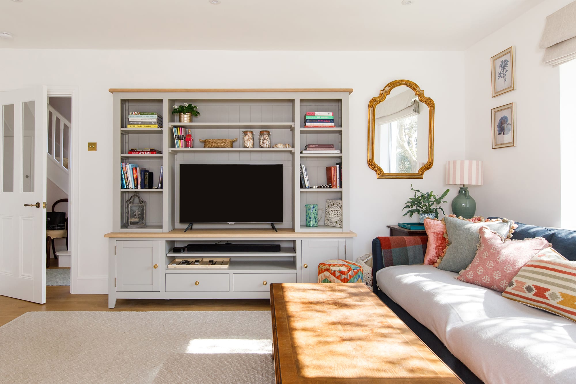 The cottage-style lounge has a log burner, comfy seating and homely touches.