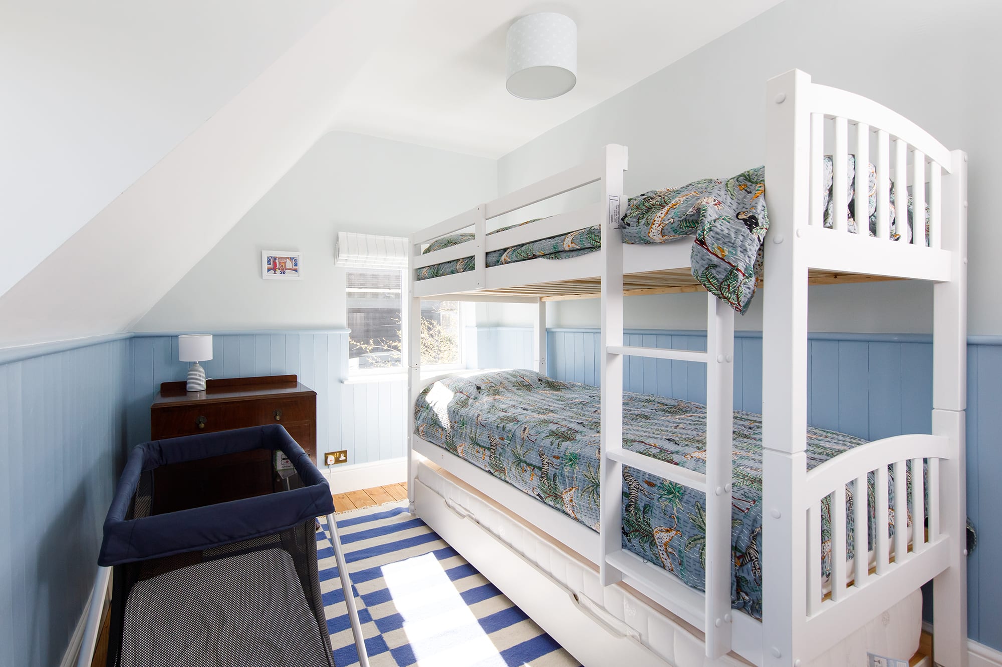 The bunk room is great for siblings. It also has a trundle bed to sleep a total of three children. The home has a travel cot and high chair, as well as stair gate.