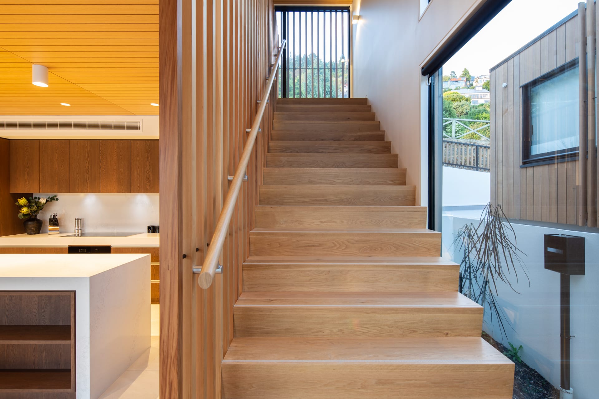 Wide stairs leading from kitchen to bedrooms
