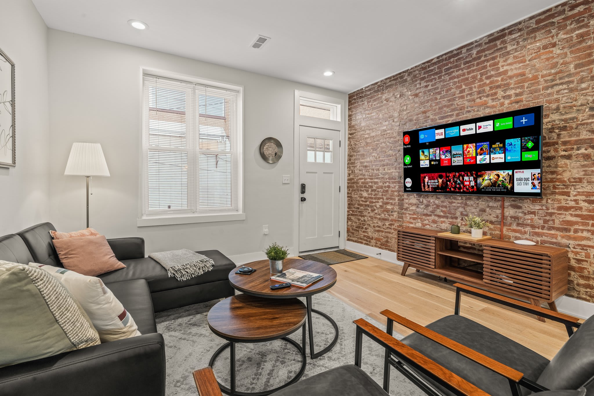 Enjoy the welcoming ambiance of this bright living area with natural light streaming through the windows. The modern furniture and beautiful rug make it the perfect place to unwind after a day of exploring.