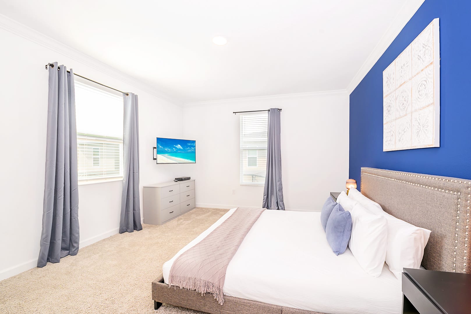 Bright Bedroom With King Bed, Smart TV, And Relaxing Blue Details