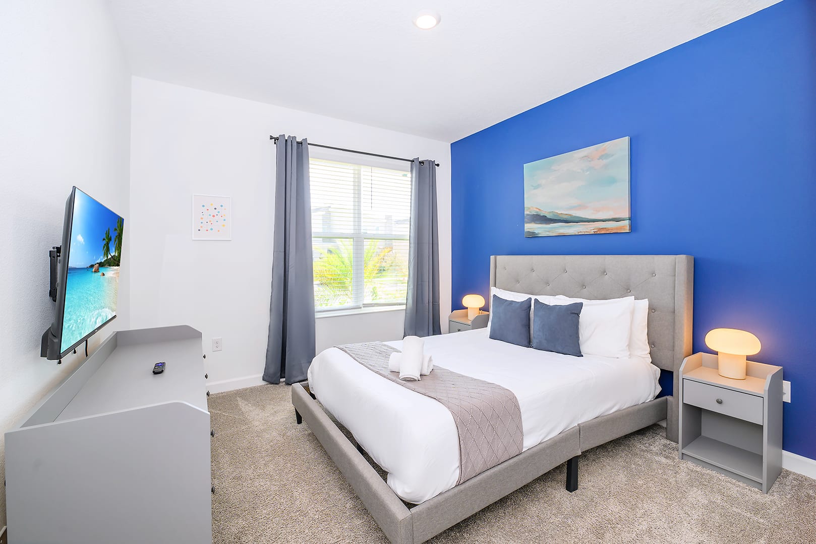 Comfortable Bedroom With A Queen Bed, Smart TV, And Elegant Style