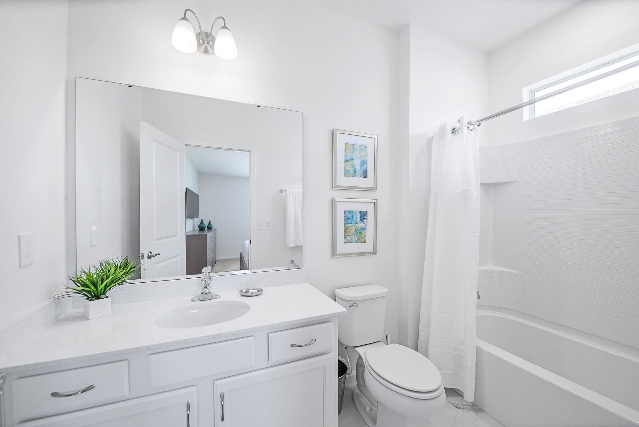 Bright And Functional Bathroom With A Shower And Vanity Space