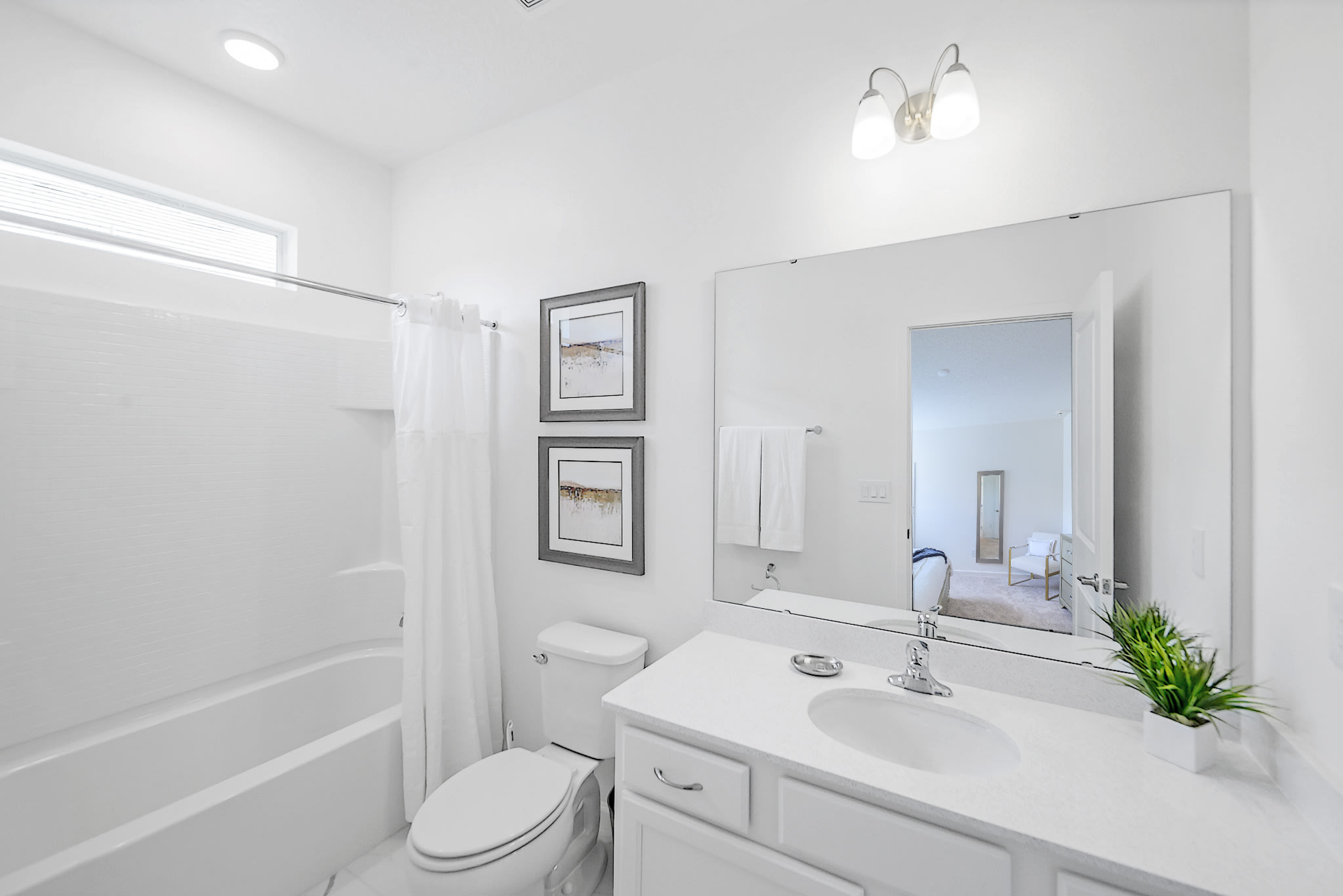 Bright And Functional Bathroom With A Shower And Vanity Space
