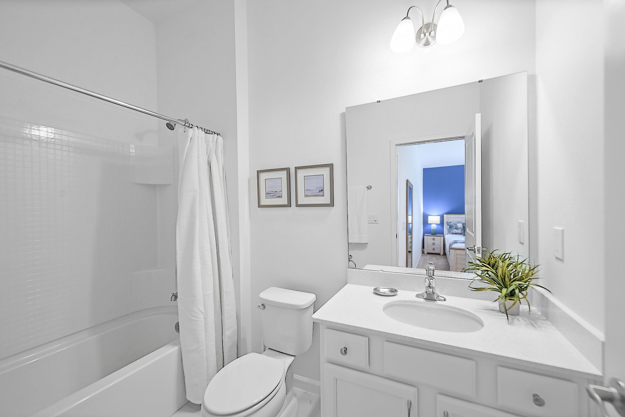 Bright And Functional Bathroom With A Shower And Vanity Space