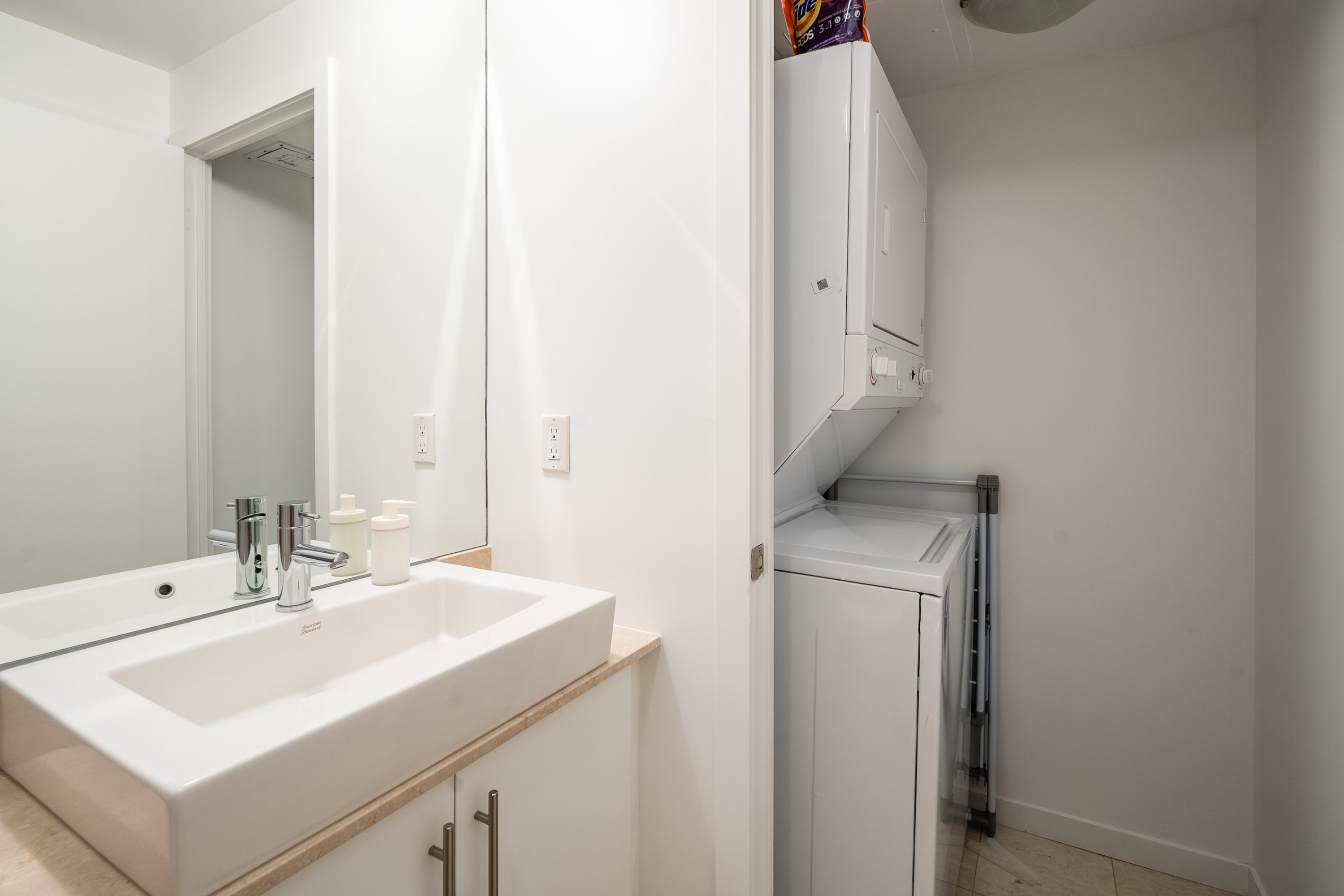 Bathroom Vanity and Laundry Area with Washer and Dryer