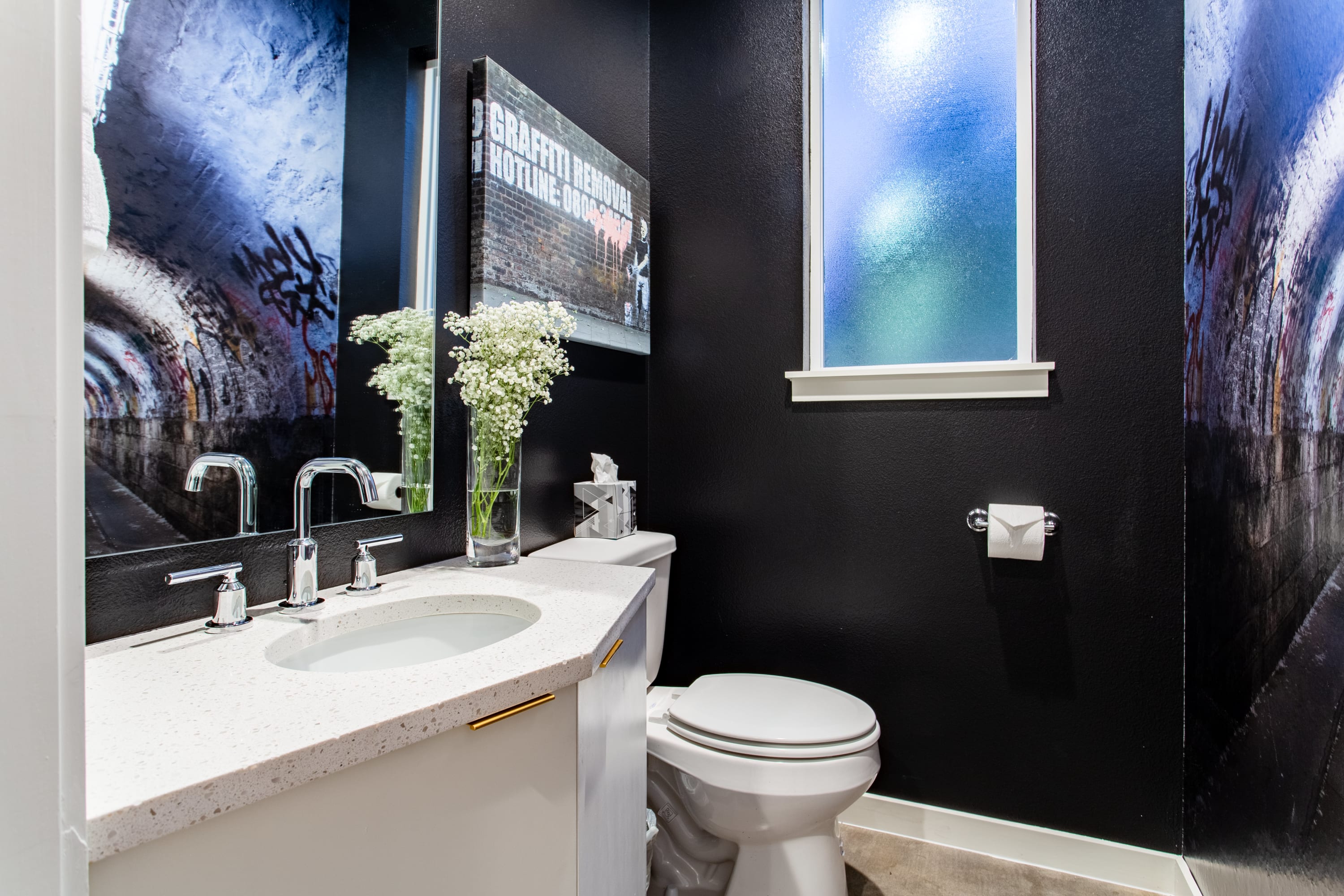 Modern Bathroom With Unique Artwork And Sleek Black Walls