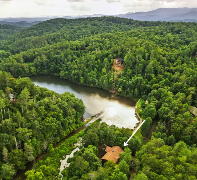 In the middle, just 12 mins to downtown Blue Ridge and Ellijay. Situated right on the water! There's only a couple of other houses on Allen Lake. Take out the paddleboards or just enjoy the views and peace with your friends and family.