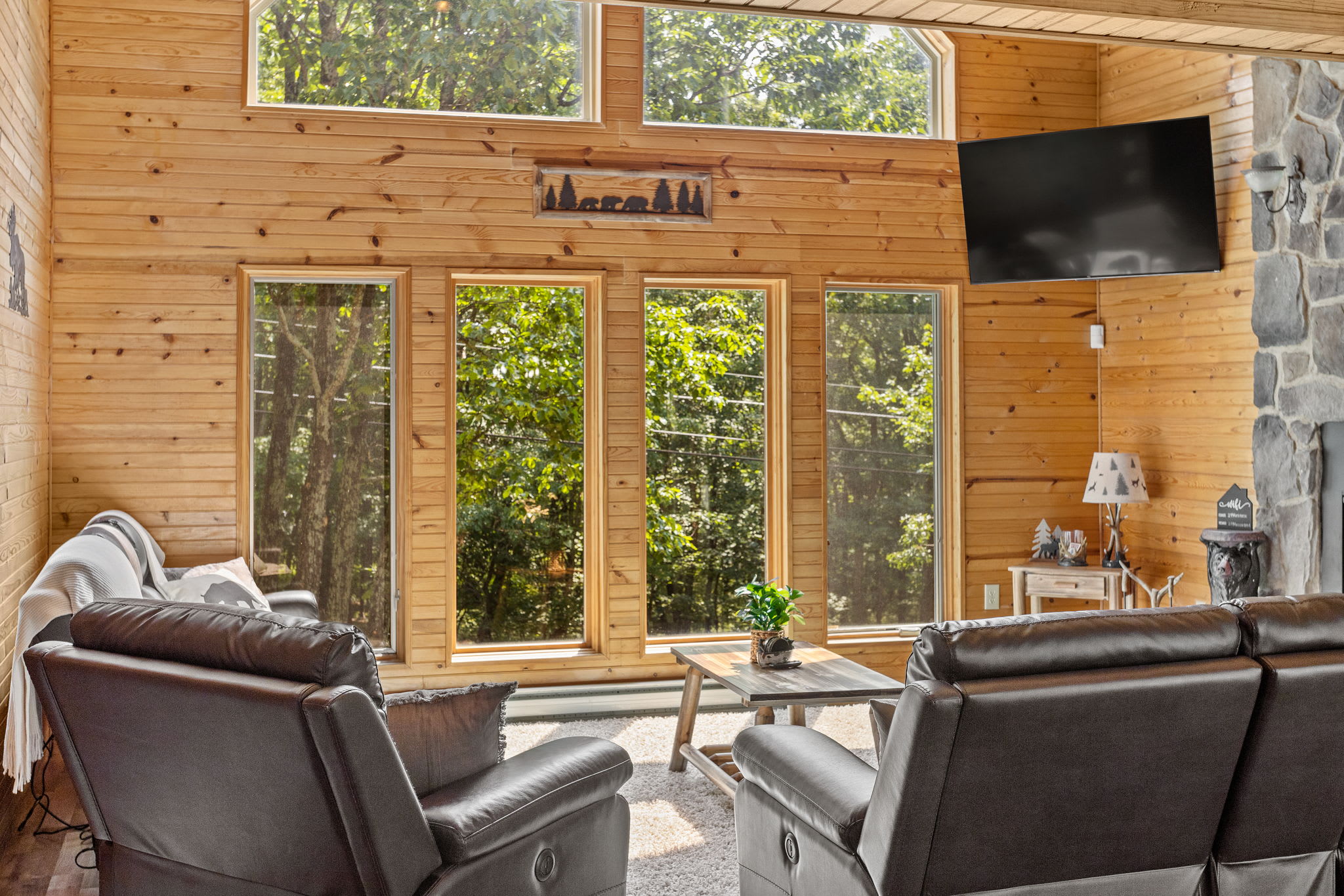 With panoramic windows framing lush greenery, this living space offers an intimate connection to nature, making it an ideal place to unwind.