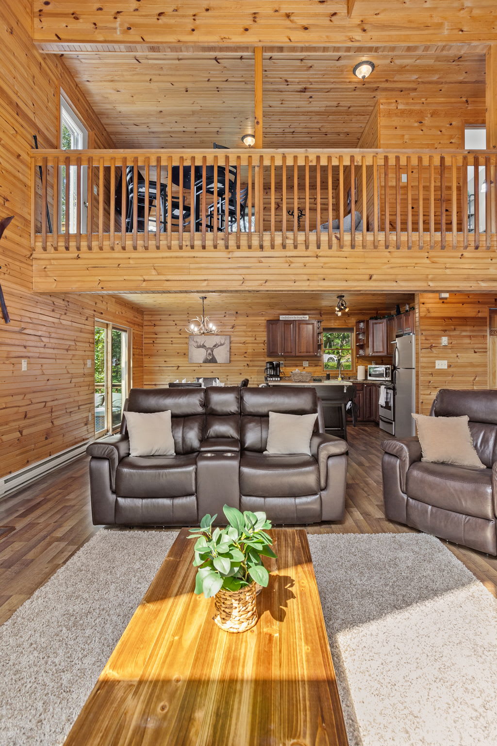 This beautifully designed home features a welcoming open layout with high vaulted ceilings, plush seating, and a cozy loft that overlooks the living area.
