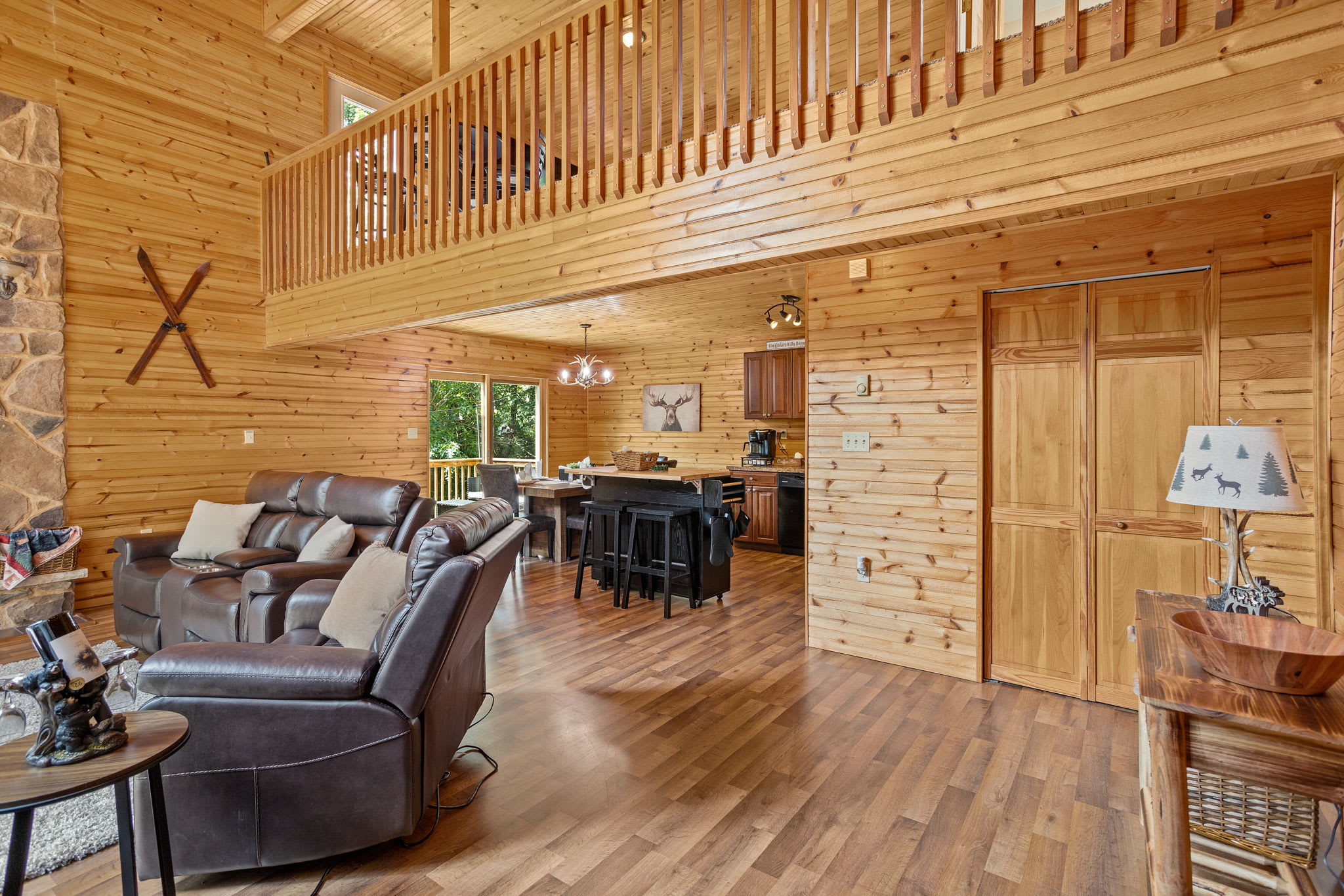 The open layout connects the spacious living room to the dining and kitchen areas, creating a bright and inviting space for gatherings.