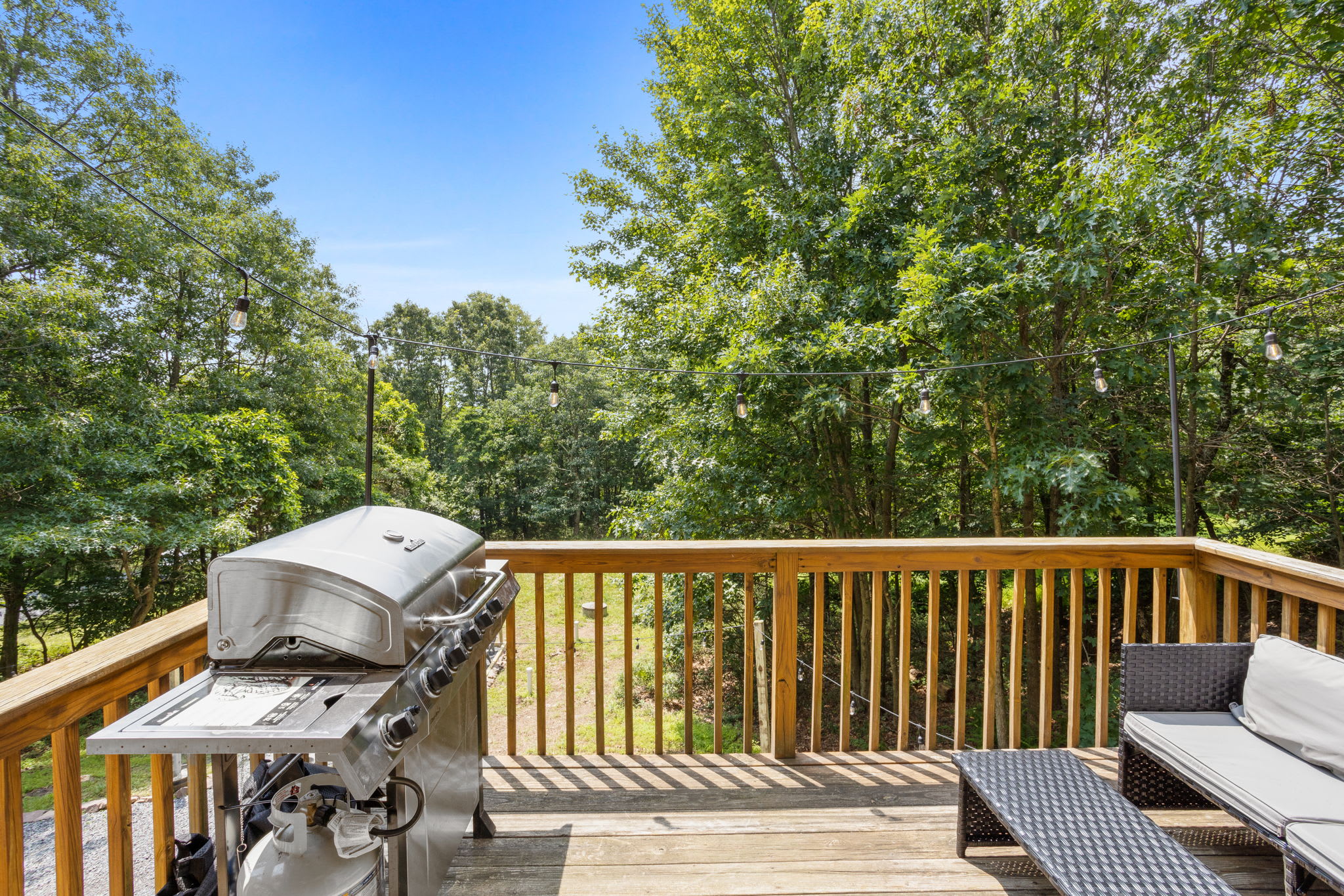 Fire up the grill and relax on the spacious deck, surrounded by lush greenery and fresh mountain air.