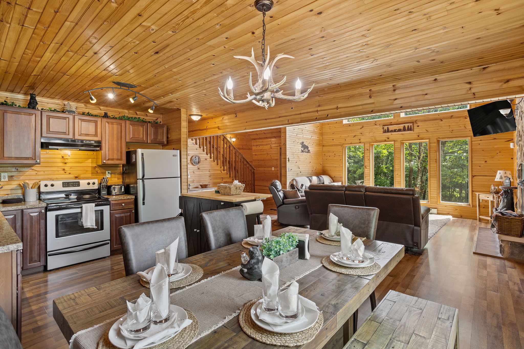 The kitchen, dining, and living areas flow together effortlessly, creating a spacious and inviting environment for guests to relax and gather.