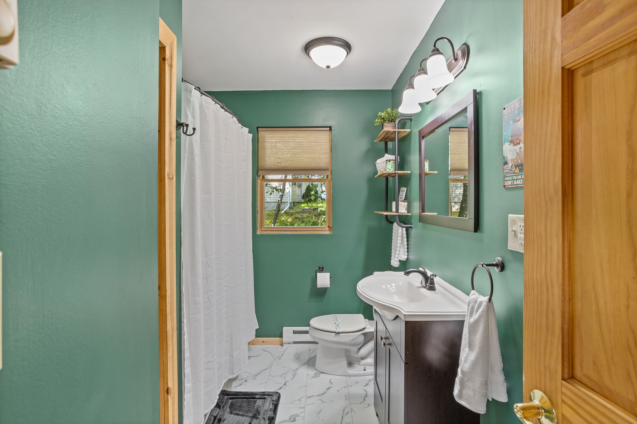 Serene & Stylish Bathroom, this modern bathroom features a refreshing green color palette, a bright vanity, and elegant touches for a spa-like feel.