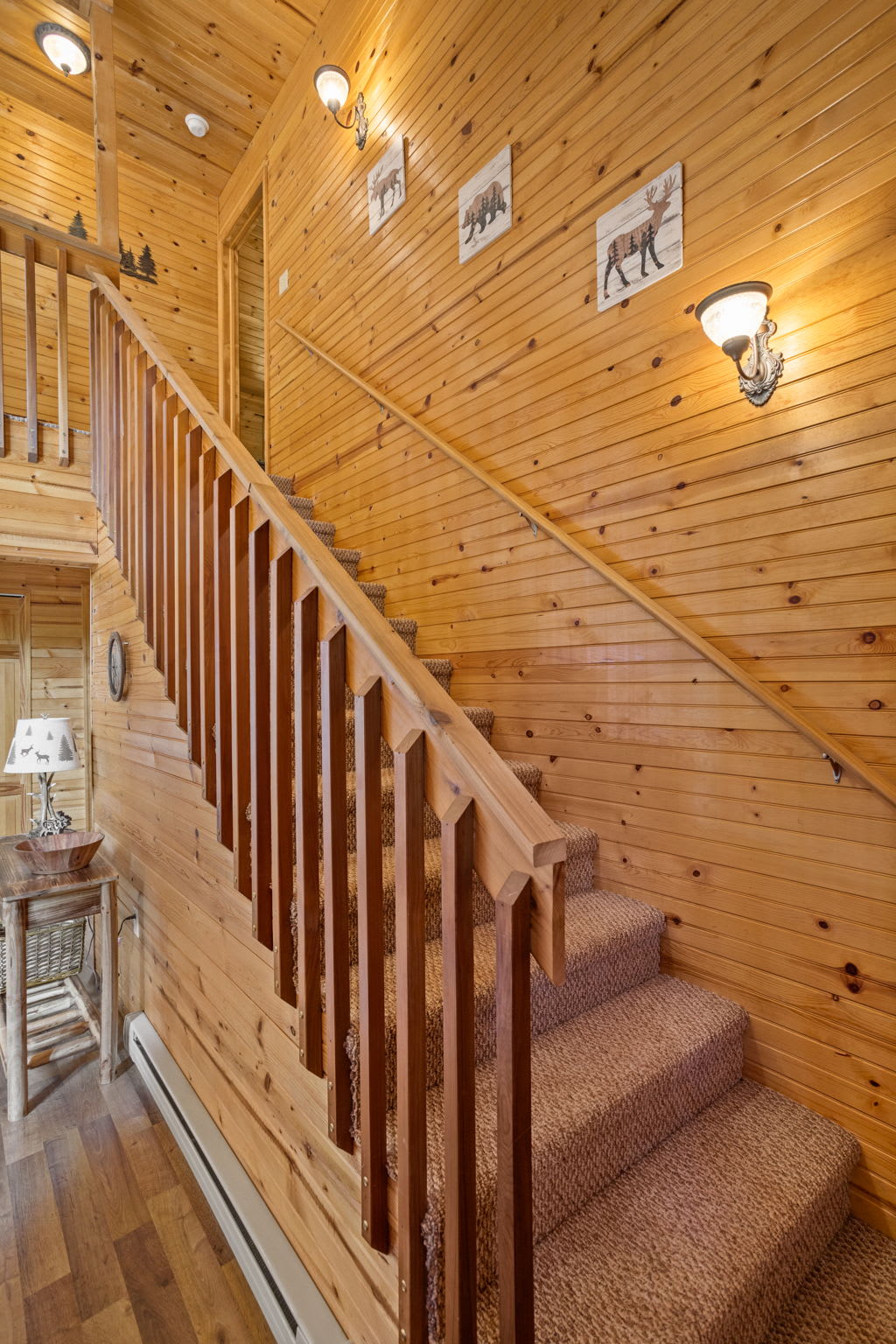 The rich wooden finishes and wildlife-inspired décor make this staircase a warm and welcoming transition between levels.