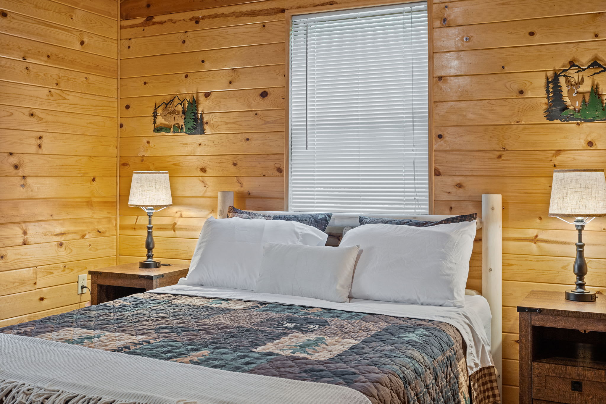 Drift off to sleep in this beautifully designed space, featuring soft lighting, cozy bedding, and peaceful cabin aesthetics.