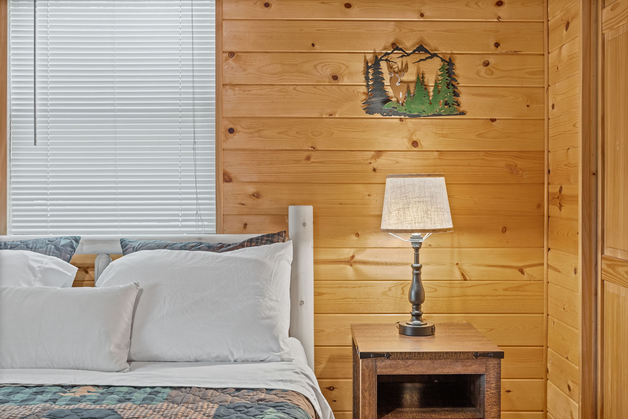 Thoughtful design elements, from handcrafted wood furniture to nature-inspired wall art, make this bedroom a true mountain escape.