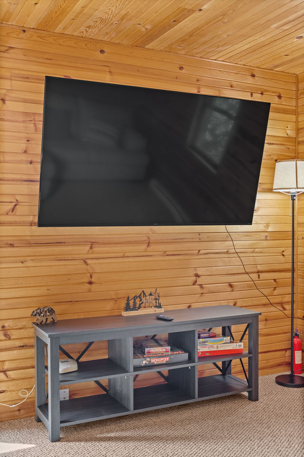 This mounted TV and stylish console provide the perfect setup for movie nights, with cozy seating nearby for ultimate relaxation.