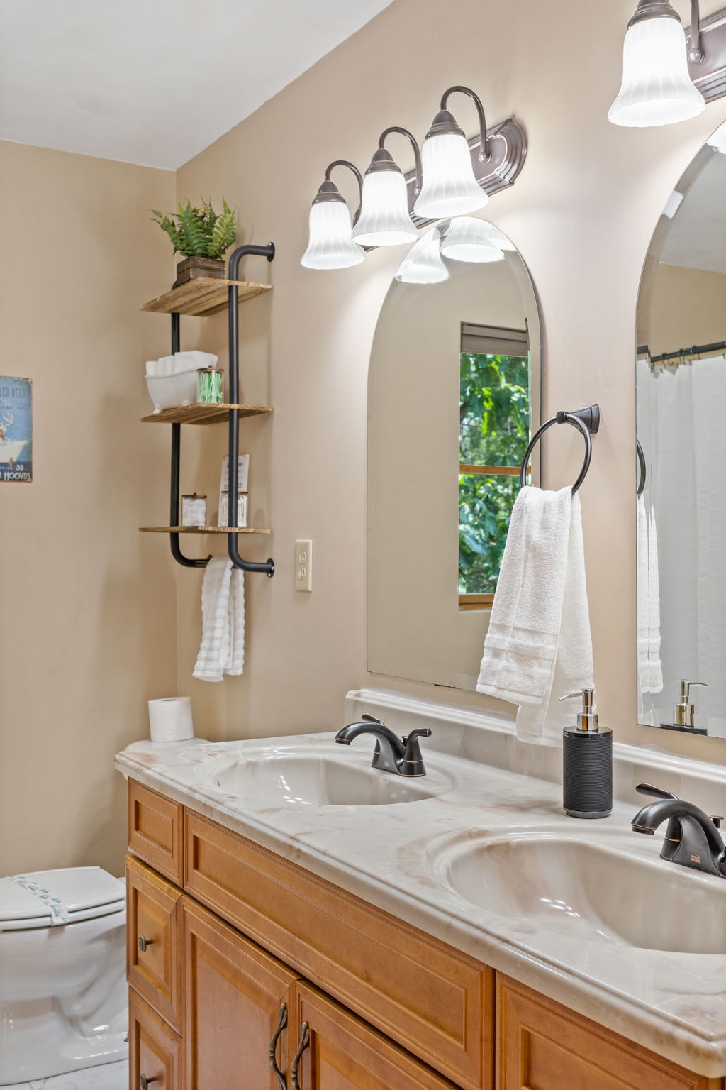 A closer look at the sophisticated double vanity, complete with black fixtures and soft lighting for a spa-like feel.