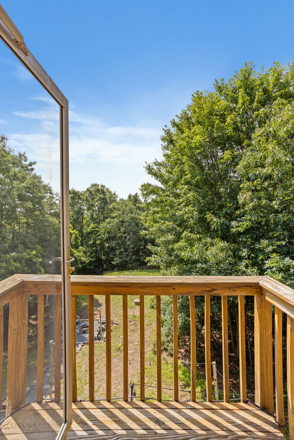 Step outside and take in the peaceful, tree-lined views from this cozy private balcony, the perfect spot for fresh air and morning coffee.