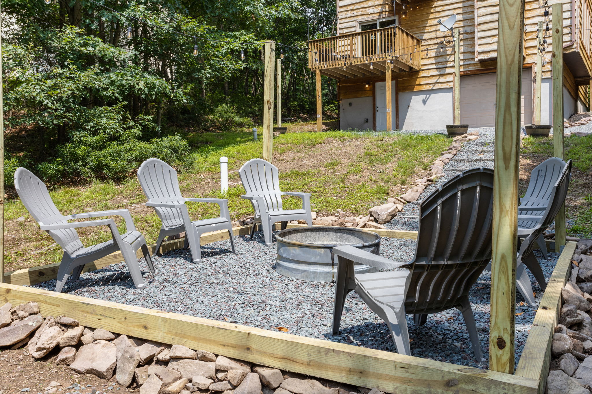 Set against a backdrop of trees, this fire pit area is designed for cozy nights and great conversations.