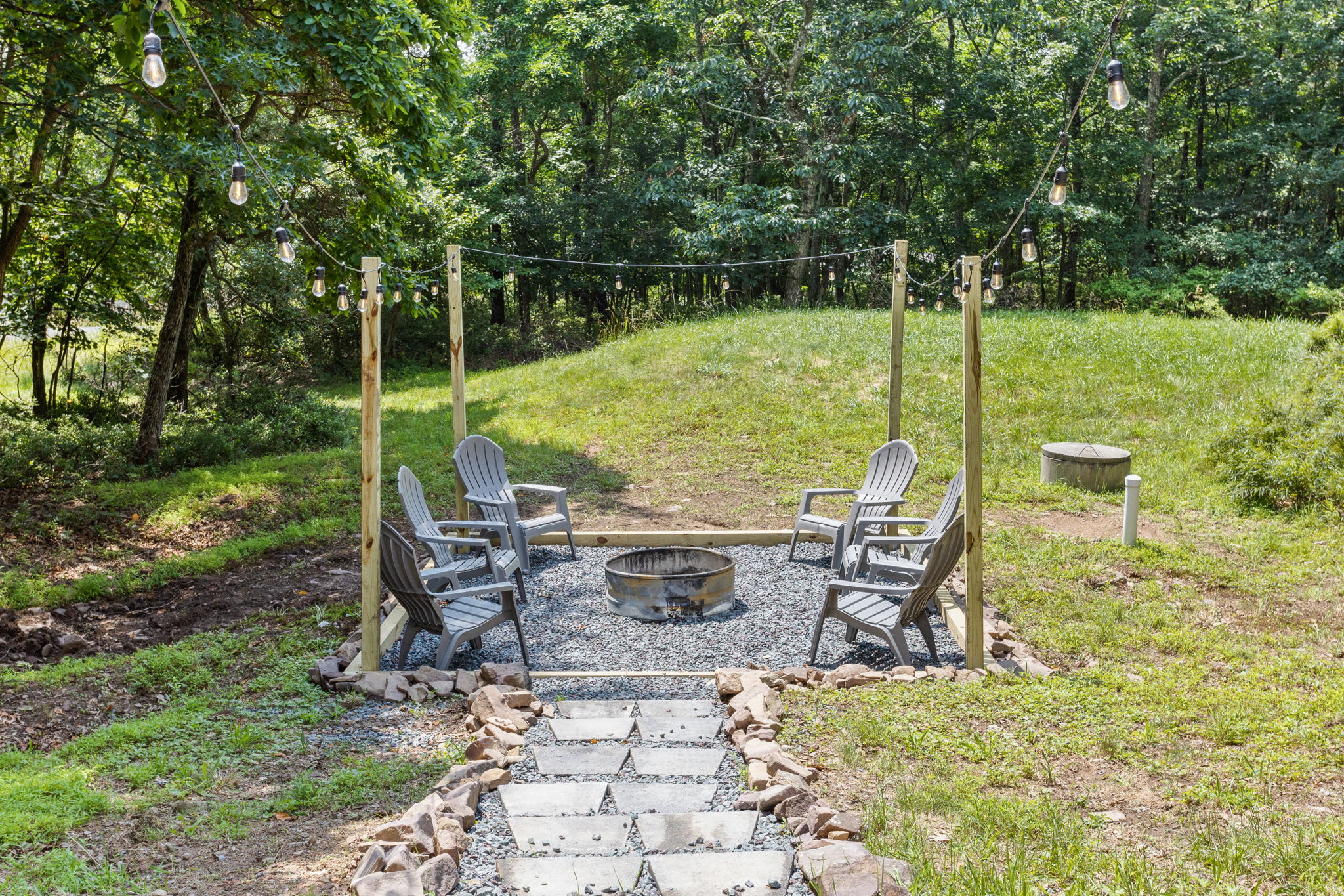 Gather around the crackling fire and enjoy the rustic ambiance created by twinkling string lights.